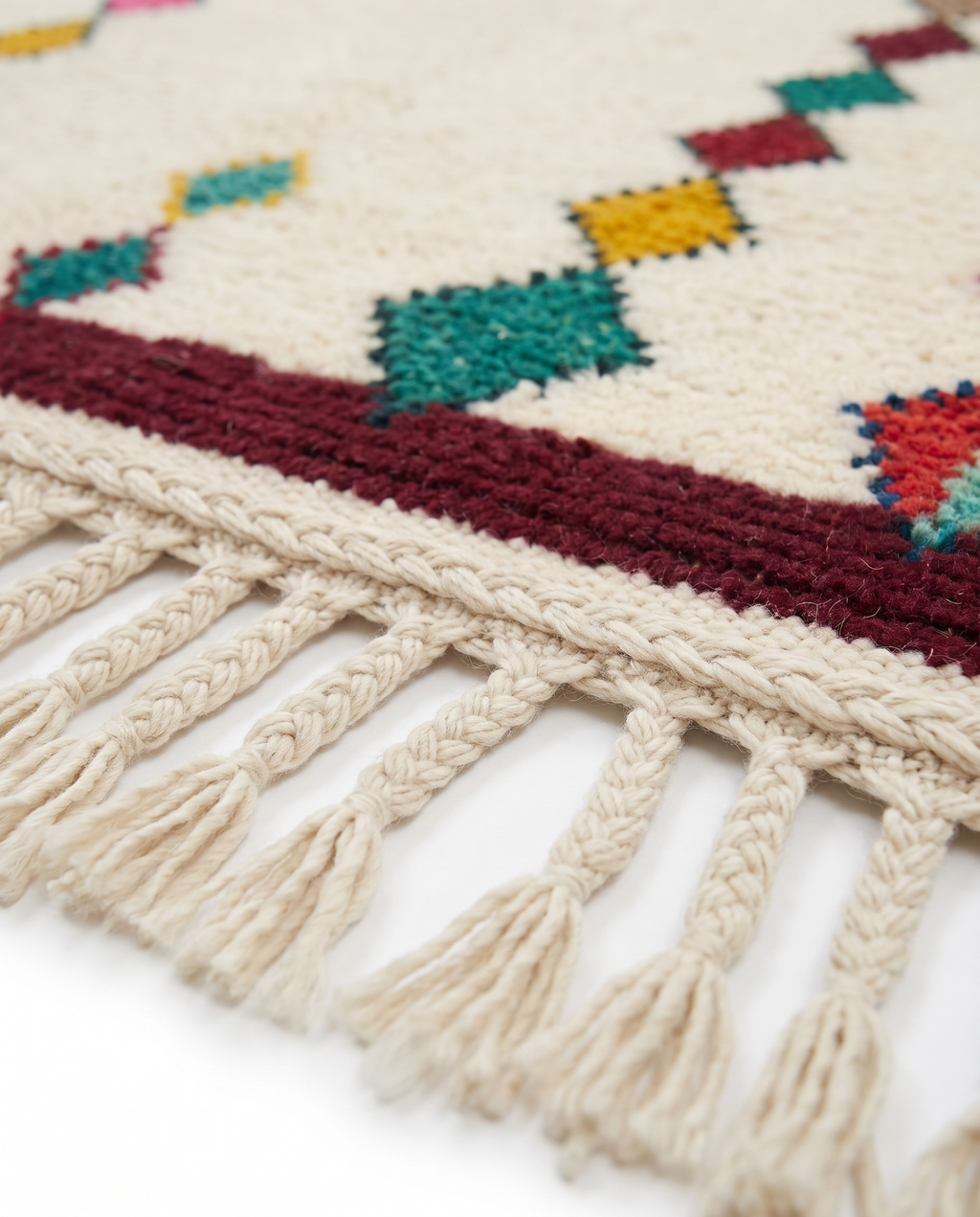 Diamond Totems Beni Ourain rug fringe detail on white studio background