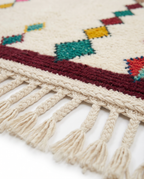 Diamond Totems Beni Ourain rug fringe detail on white studio background