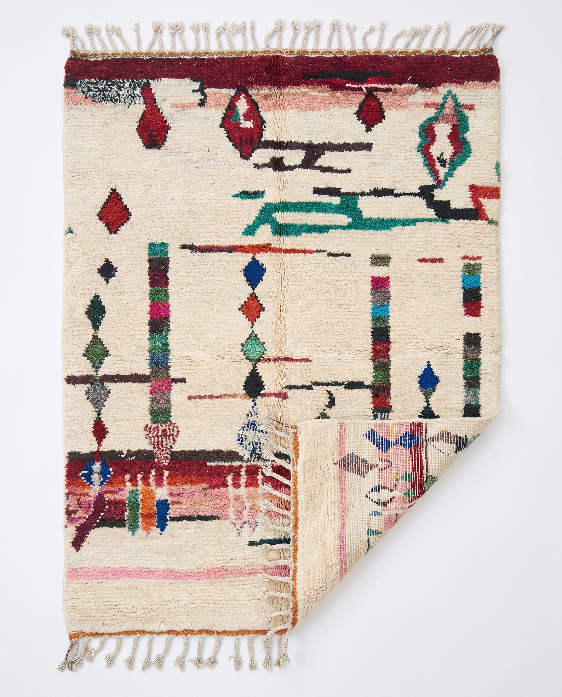 Diamond Totems Beni Ourain rug folded corner on white studio background