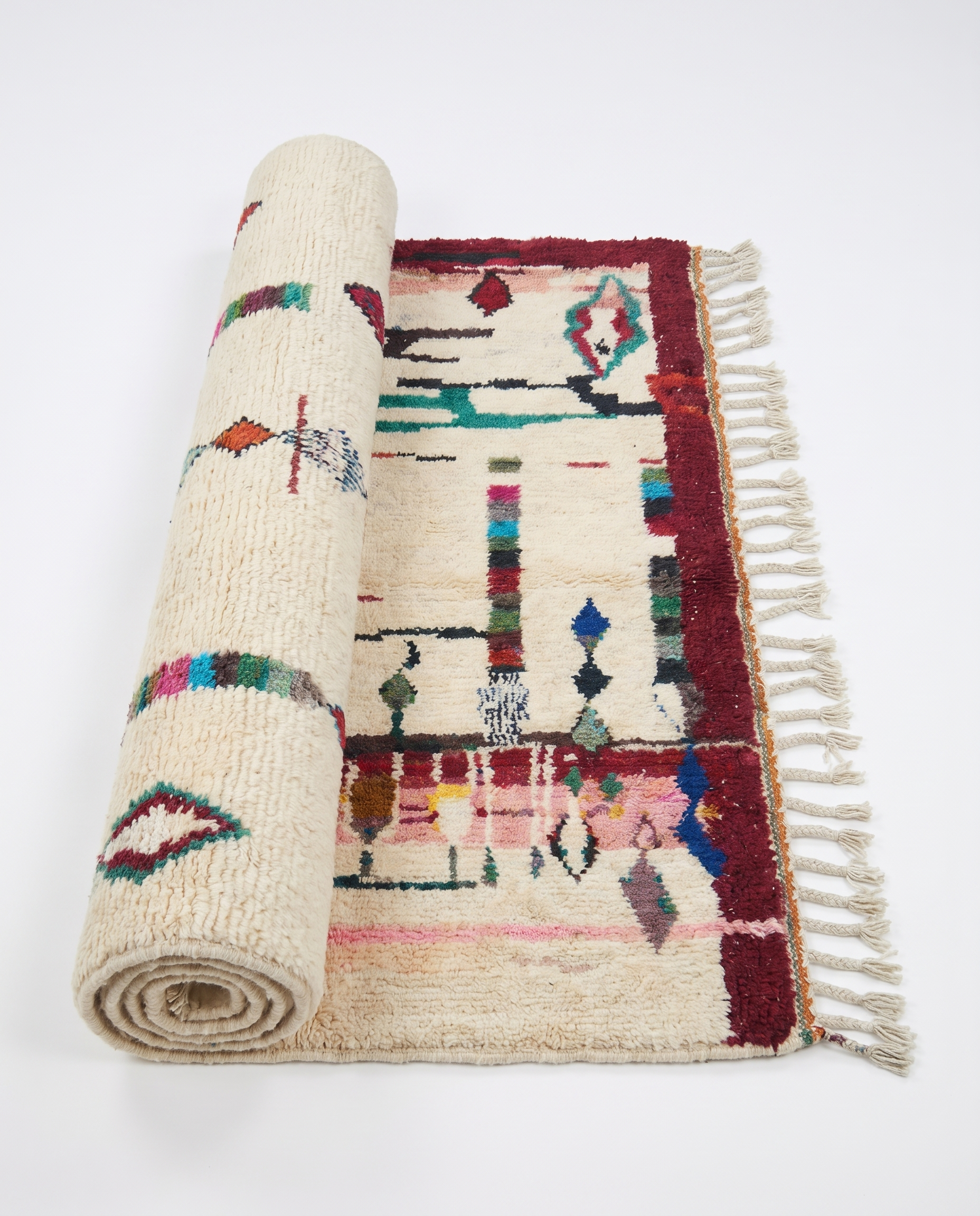 Diamond Totems Beni Ourain rug half-rolled on white studio background