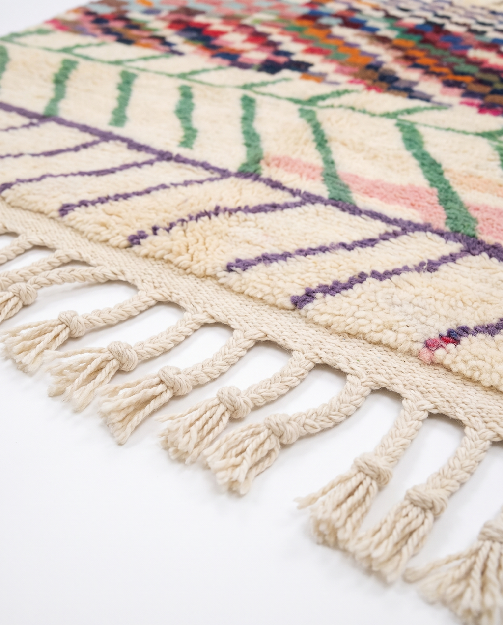 Chevron Mosaic Beni Ourain rug fringe detail on white studio background