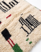 Village Signs Beni Ourain rug wool texture close-up on white studio background