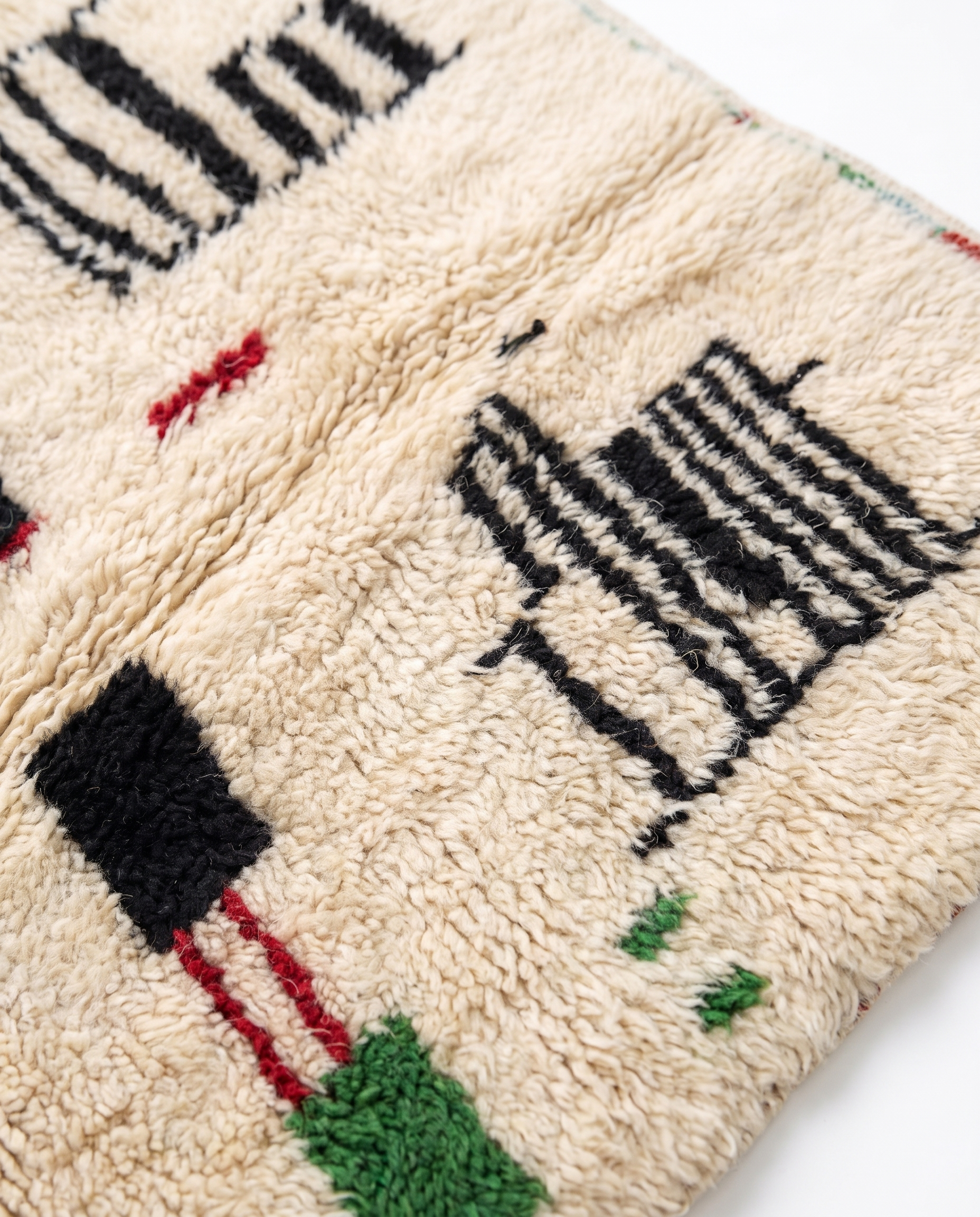 Village Signs Beni Ourain rug wool texture close-up on white studio background