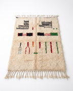 Village Signs Beni Ourain rug full view at an angle on white studio background