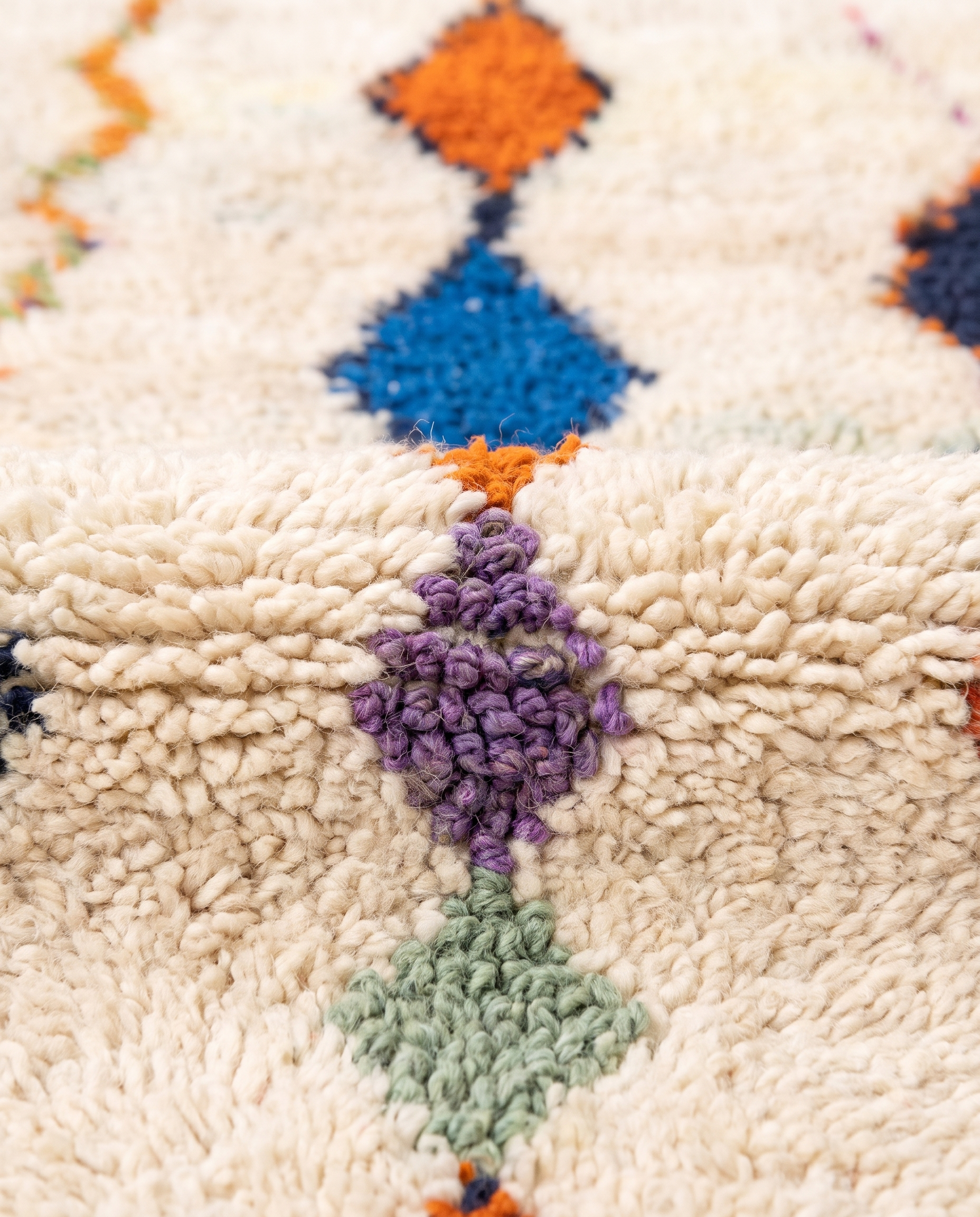 Diamond Cascade Beni Ourain rug wool texture close-up on white studio background