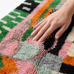Meadow Confetti Azilal rug — hand resting on the soft wool pile