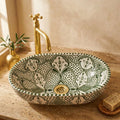 Olive Fessi Moroccan ceramic vessel sink styled on a bathroom counter in a Moroccan-inspired setting