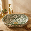 Olive Fessi Moroccan ceramic vessel sink styled on a bathroom counter in a Moroccan-inspired setting