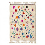 Playful Sprinkle Azilal rug, handwoven wool with scattered bright multicolor shapes, flat lay top view