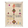 Rainbow Totem Azilal rug, handwoven wool with pink, yellow, green, blue and black scattered motifs, flat lay top view