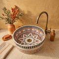 Saffron Arabesque Drum Moroccan ceramic vessel sink styled on a bathroom counter in a Moroccan-inspired setting
