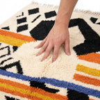 Saffron Jazz Azilal rug — hand resting on the soft wool pile