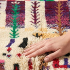 Tribal Canvas Azilal rug — hand resting on the soft wool pile
