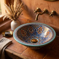 Turquoise Fessi Heritage Moroccan ceramic vessel sink styled in a Moroccan bathroom with brass faucet