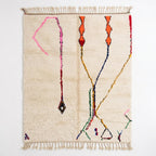 Whisper Lines Azilal rug, handwoven wool with sparse pink, orange, red and blue line motifs, flat lay top view