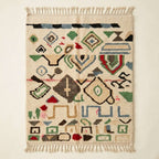 Wild Symbols Azilal rug, handwoven wool with green, rust, blue and red abstract symbols, flat lay top view